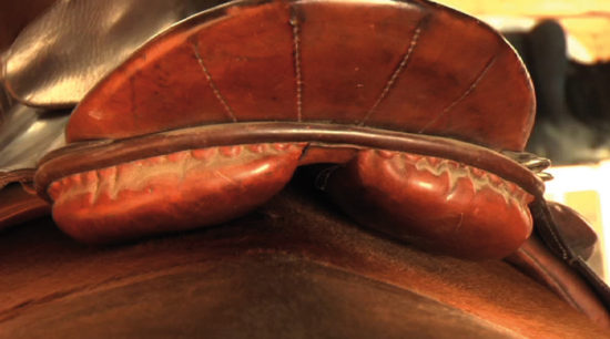 This older military saddle has many advantages in its design which should be taken into consideration by modern saddle manufacturers: 1. the trapezius muscles is freed up during movement; 2. the back of the panel is curved up to allow the horse's back to come up when fully engaged; 3. The gullet channel is nice and wide so there is no pressure on the lumbar vertebrae during lateral movement or turns.